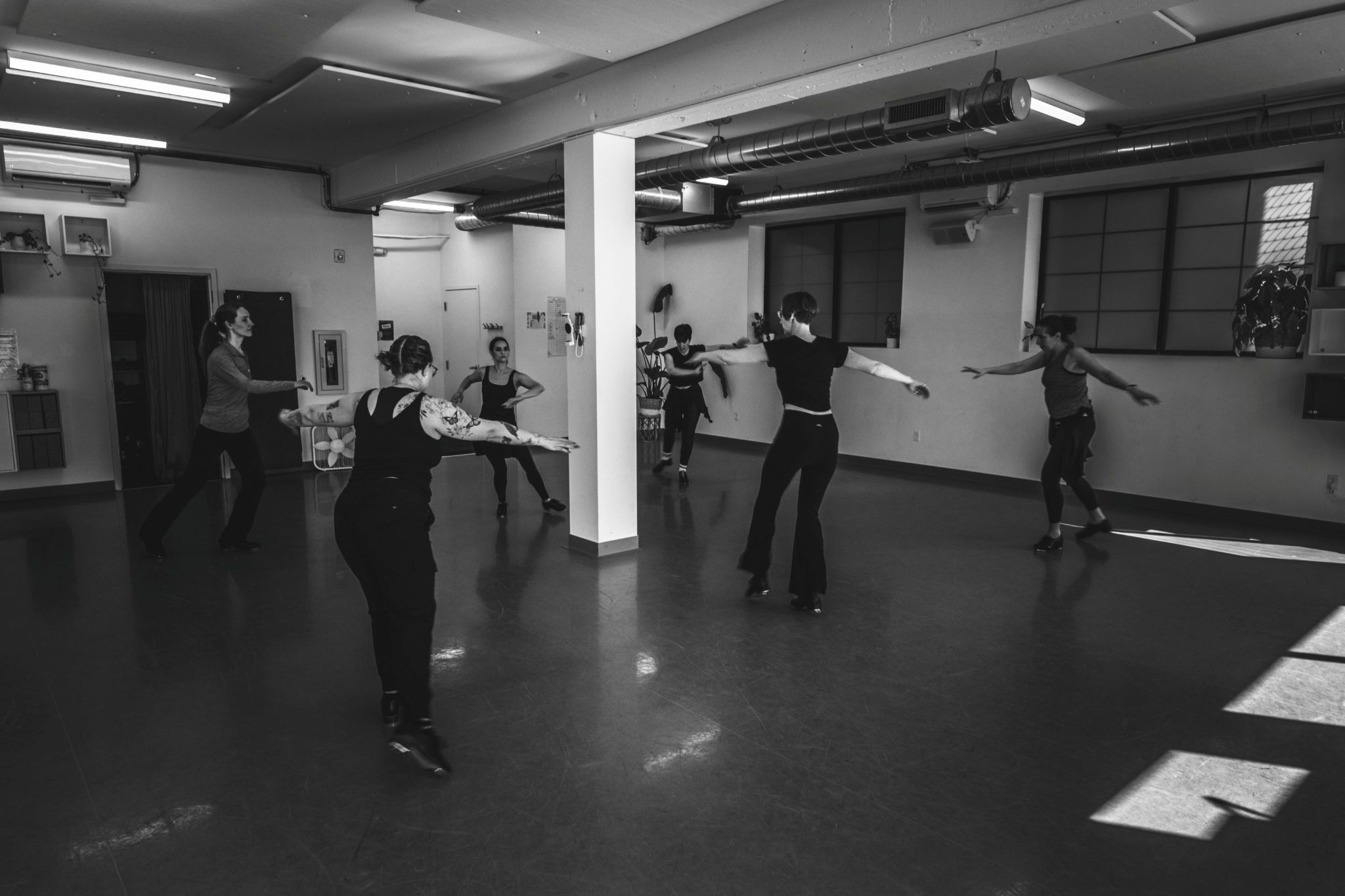 Black and white photo of Rain City Tappers in the studio at University of Washington