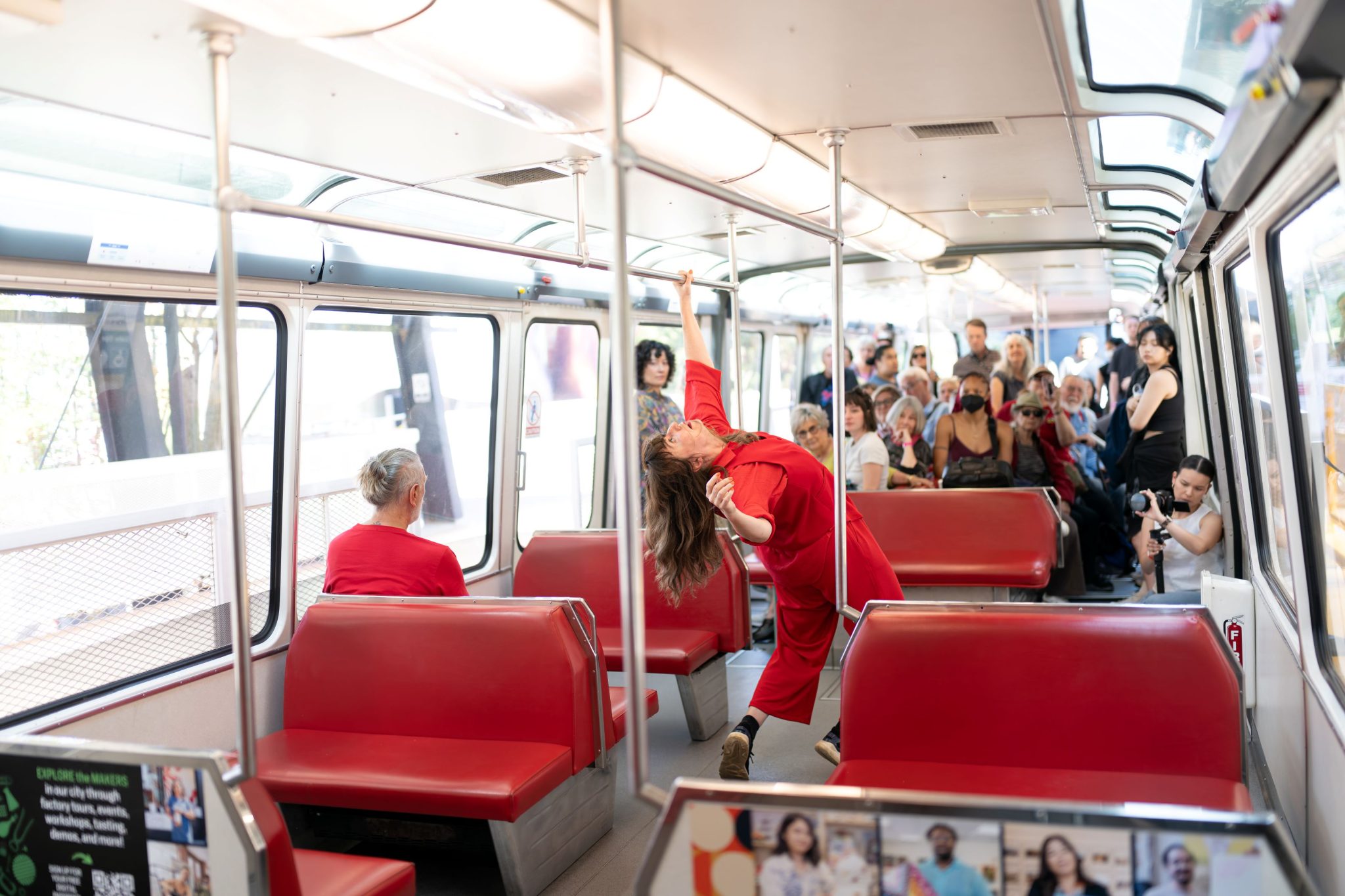Lockyer wearing red bending backwards on the monorail with red seats