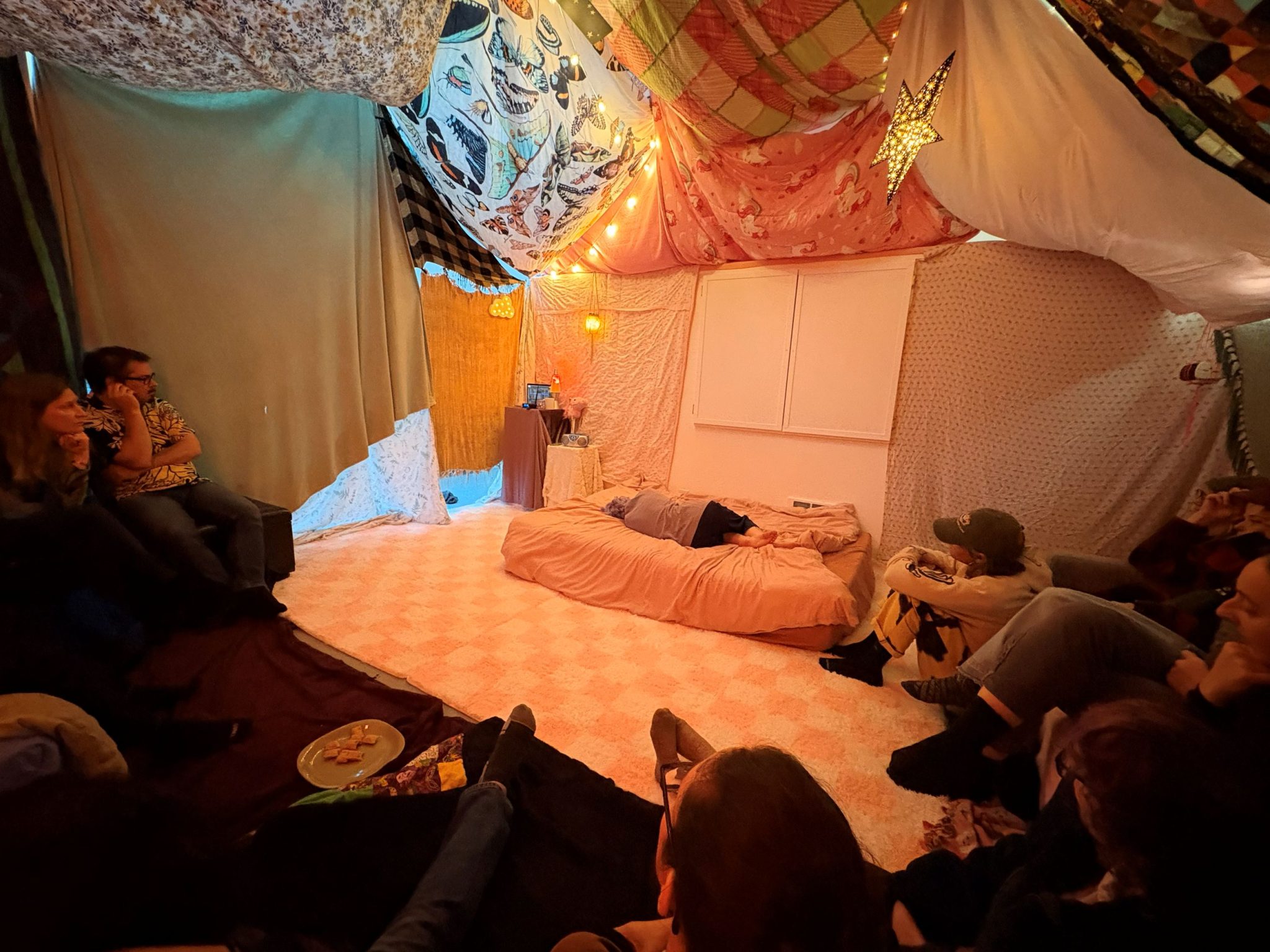 Audience city in semi-circle on the ground in blanket fort in Mini Mart City Park